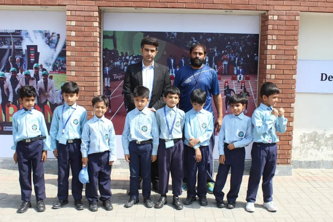 Students and teachers outside the school building