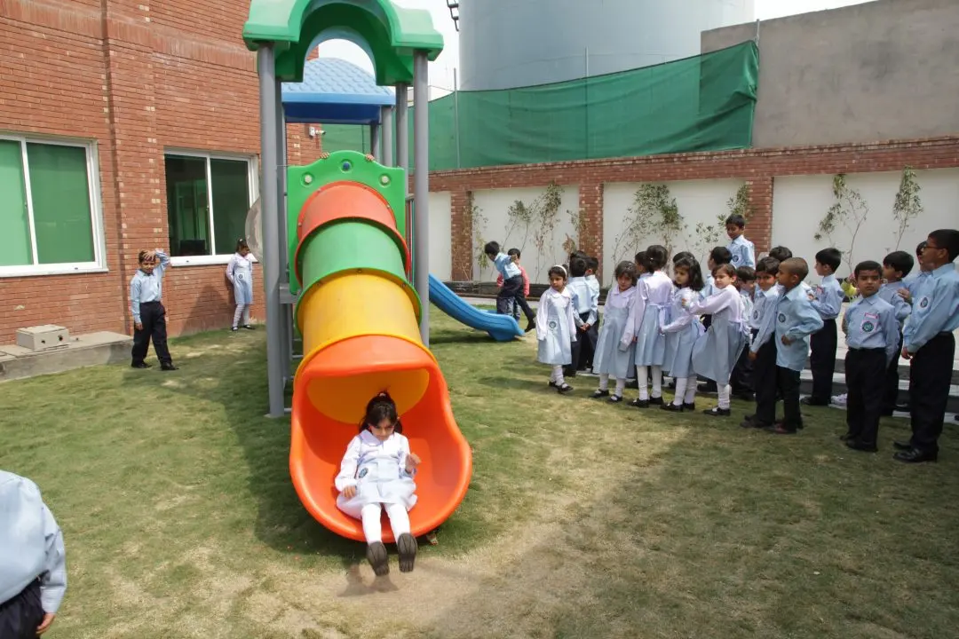 Students around the slide in the play area